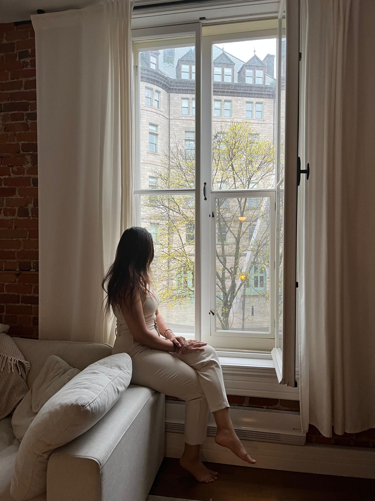 Woman staring outside feeling numb all of a sudden at Manhattan