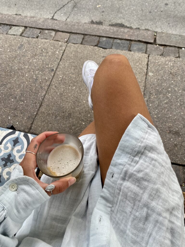 Woman sitting outside the coffee shop still feeling disconnected at Brooklyn