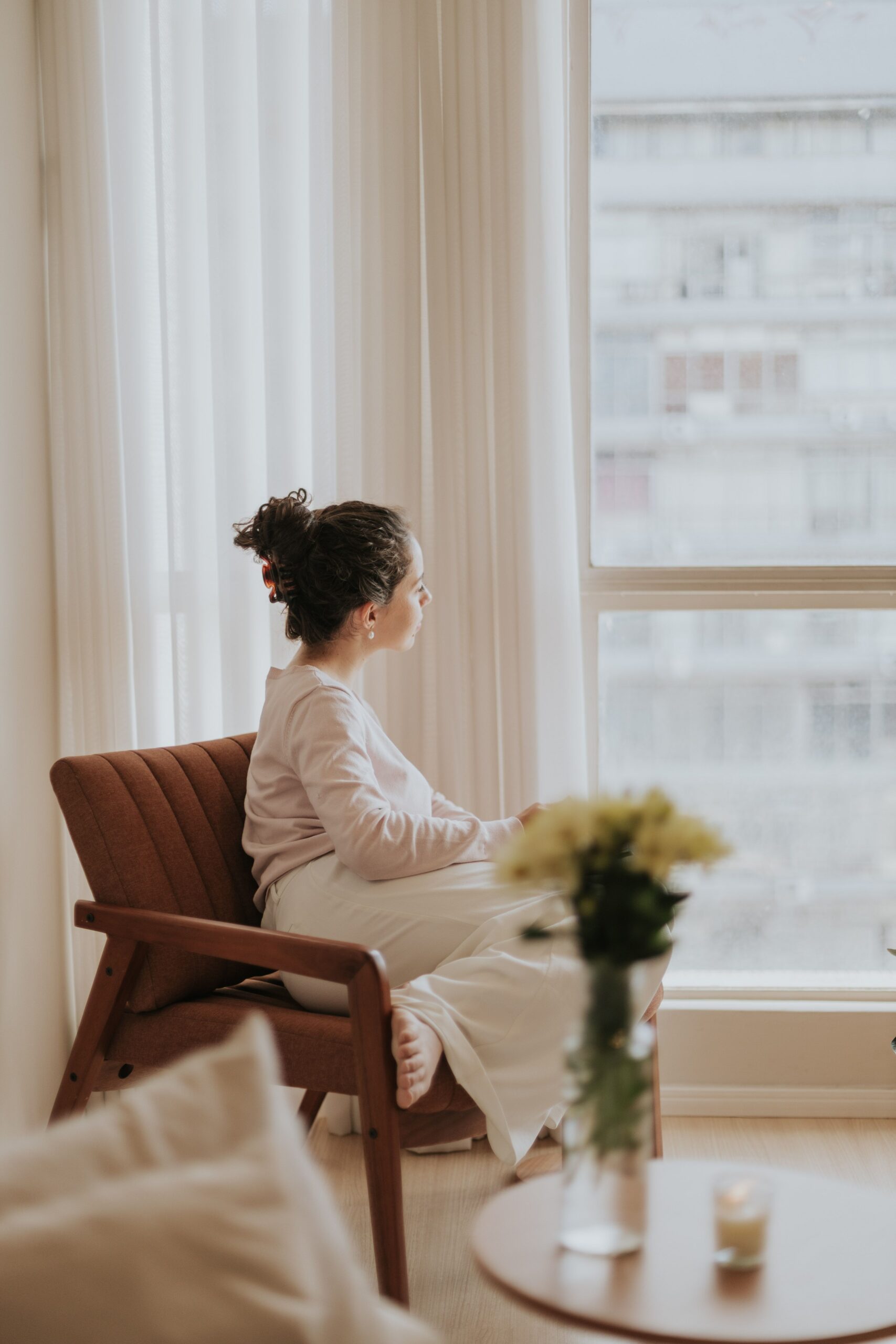 Woman reflecting by her window at Manhattan