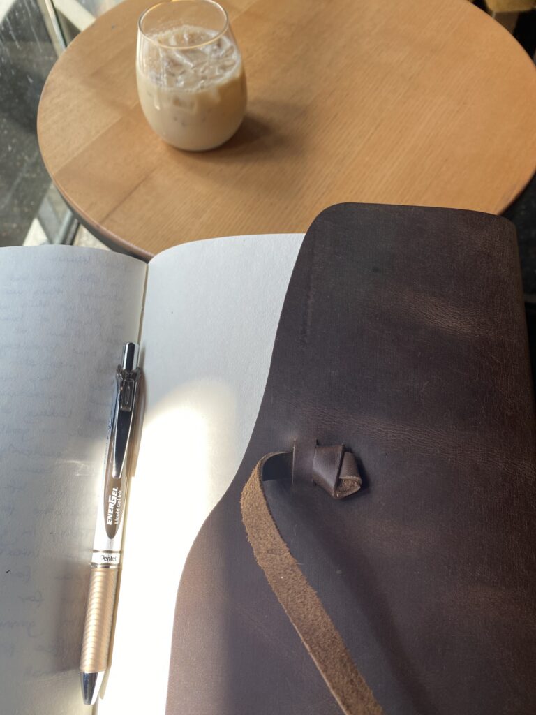 Person writing on her journal to ease their mind at Brooklyn