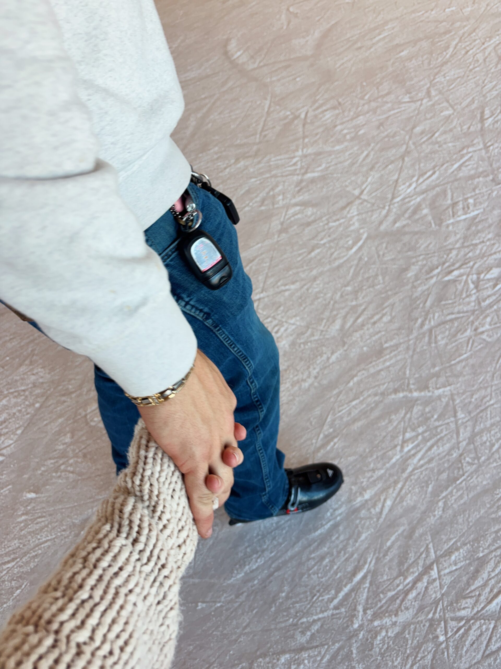 Couple walking while holding each other's hands at Manhattan