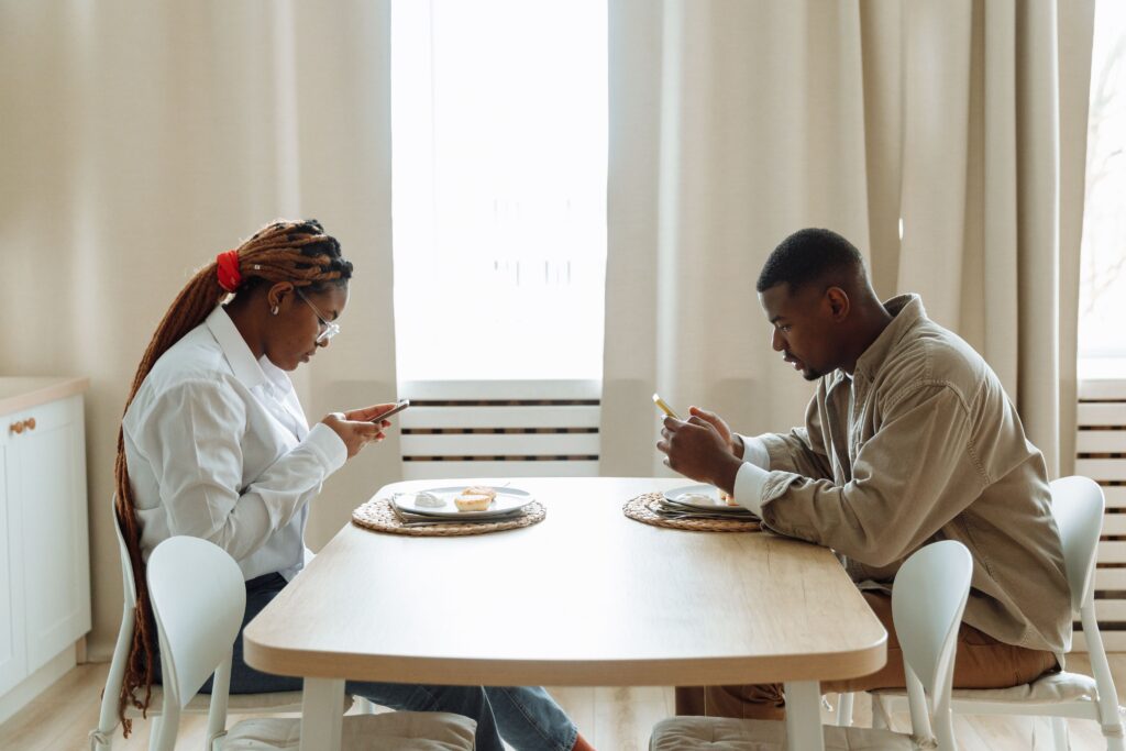 Couple focusing on their phones and not interacting with each other at New York