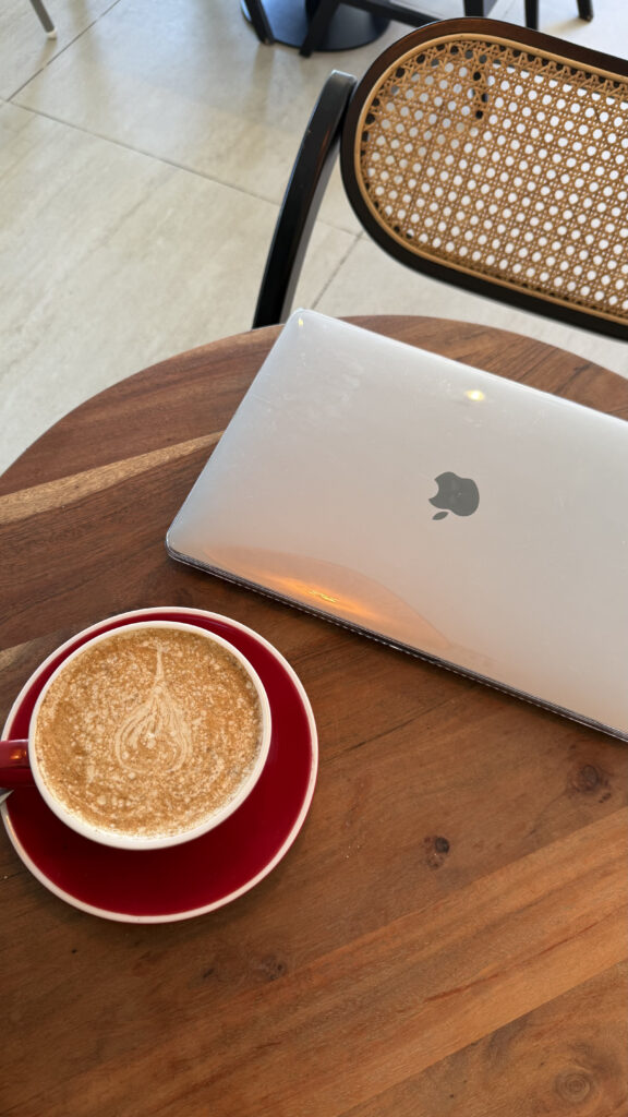 A person pausing on work and enjoying their coffee at a cafe in New York