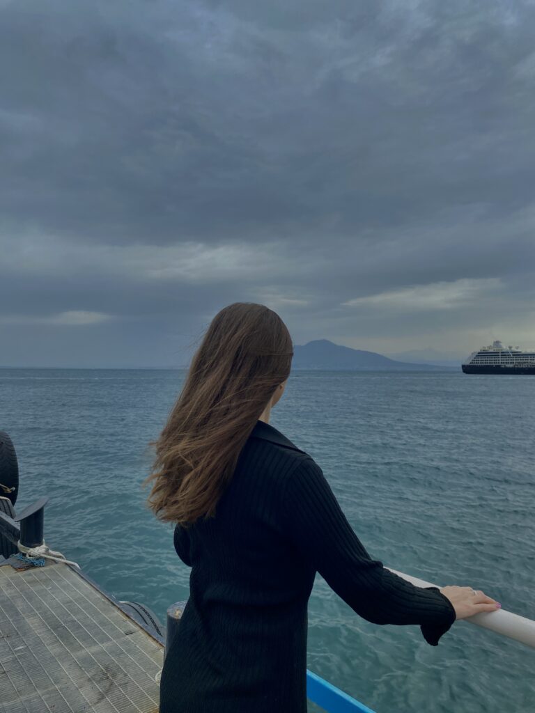 Woman overthinking on her relationship alone by the beach at New York