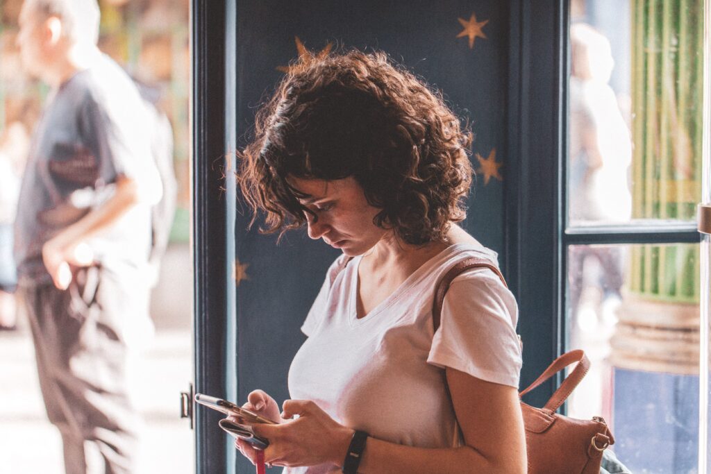 Woman anxiously checking her phone every minute at Brooklyn